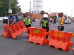 sekat jalSejumlah petugas tengah memasang alat penyekat di salah satu ruas jalan.an Sejumlah petugas tengah memasang alat penyekat di salah satu ruas jalan.